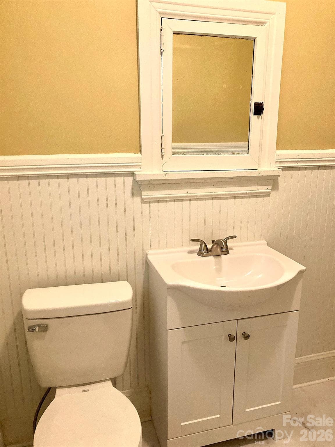 Hall bath features new vanity, toilet and floor covering. - 326 S 3rd Street, Albemarle