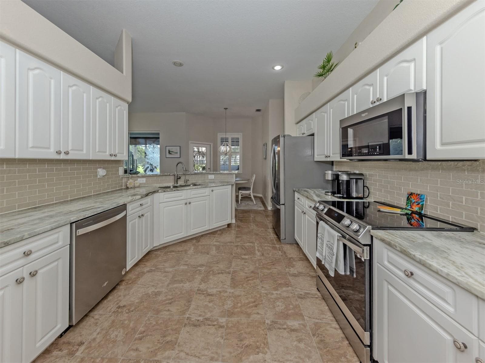 Where style meets everyday convenience! This thoughtfully designed kitchen offers generous counter space, an inviting layout, and all the little touches that make cooking and entertaining a pleasure! - 443 BERMUDA ISLES CIR, VENICE