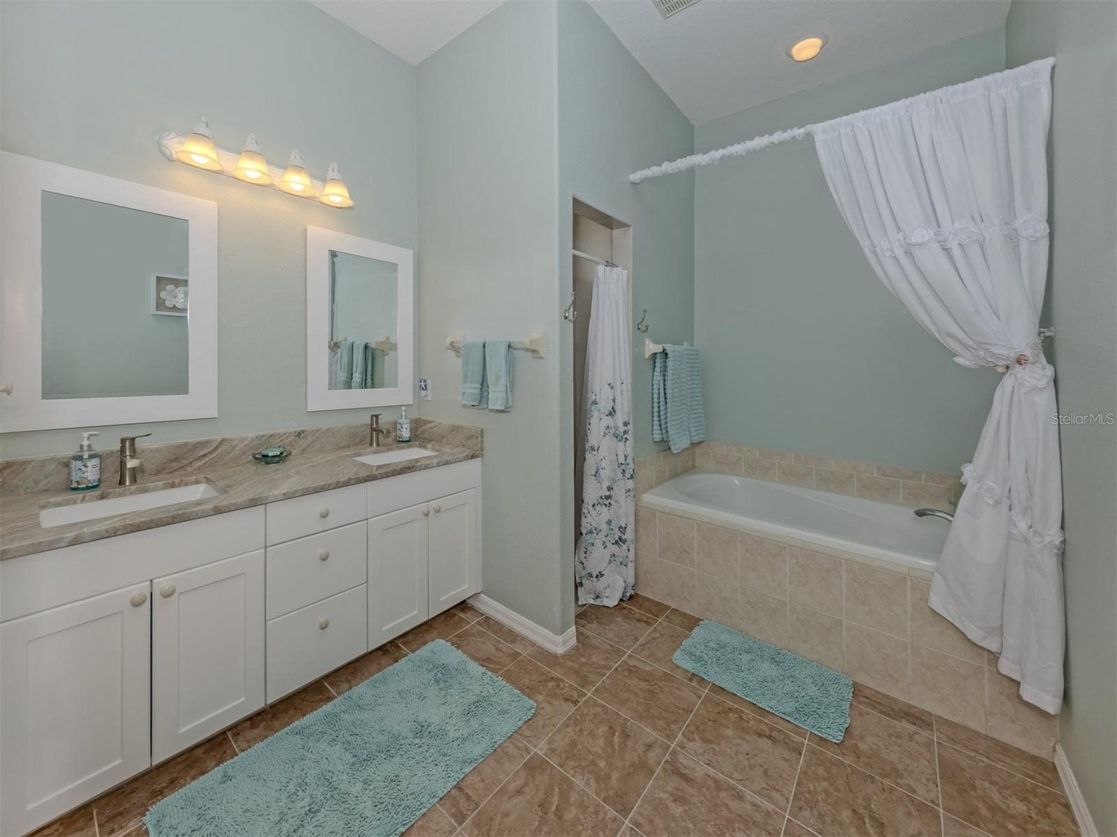 A beautiful blend of comfort and elegance! This spacious primary ensuite features gorgeous granite countertops with dual sinks, a refreshing walk-in shower, a separate soaking tub for those well-deserved moments of relaxation, recessed lighting, and a private water closet. Your own little retreat to refresh, relax, and unwind! - 443 BERMUDA ISLES CIR, VENICE