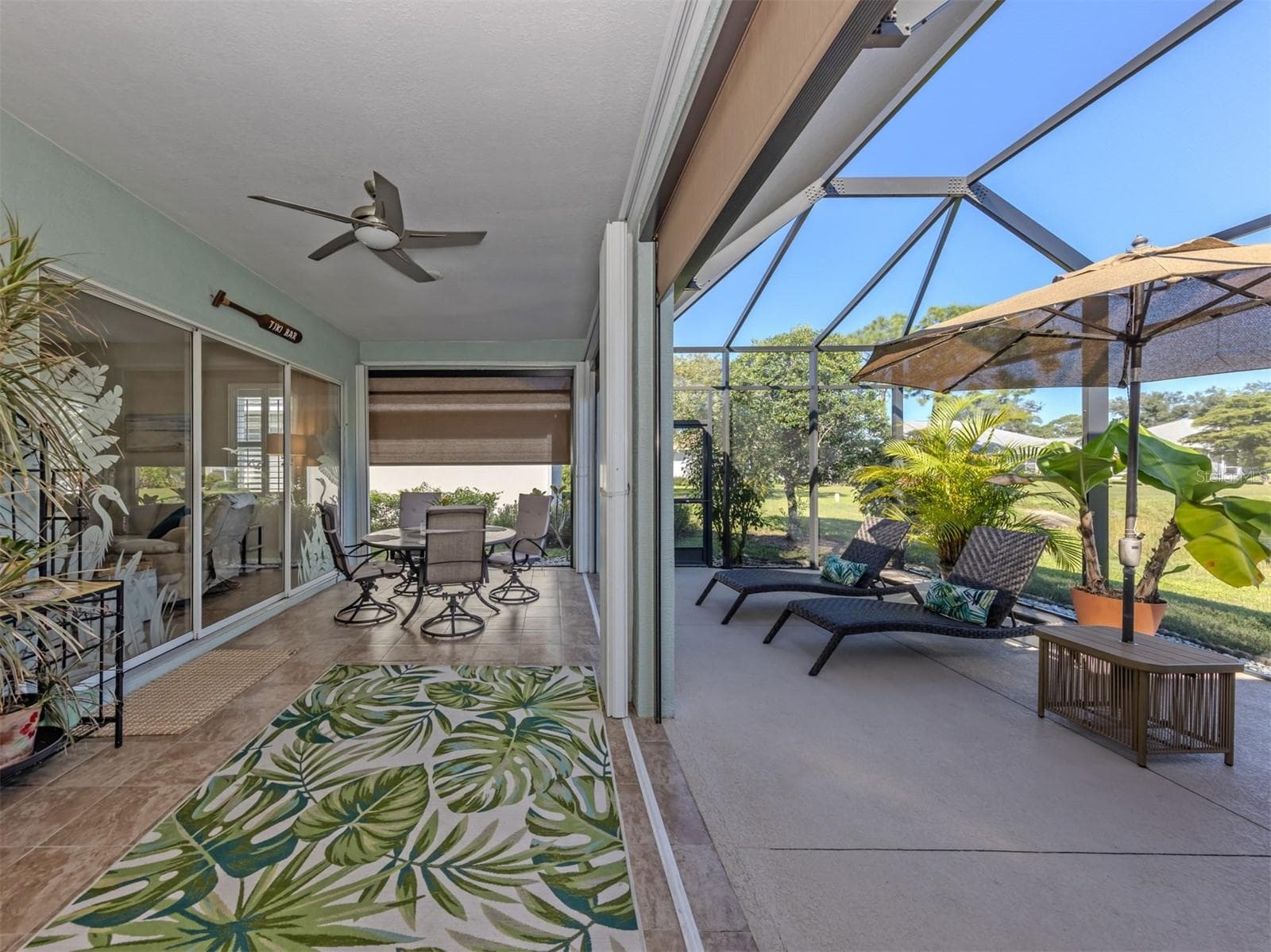 Your favorite room might just be outdoors! Enjoy dinner beneath the covered lanai, then wander into the spacious screened extension to catch the breeze. With the touch of a button, electric shades adjust to your liking, while already-installed hurricane shutters slide shut when needed. It's outdoor living made wonderfully easy! - 443 BERMUDA ISLES CIR, VENICE