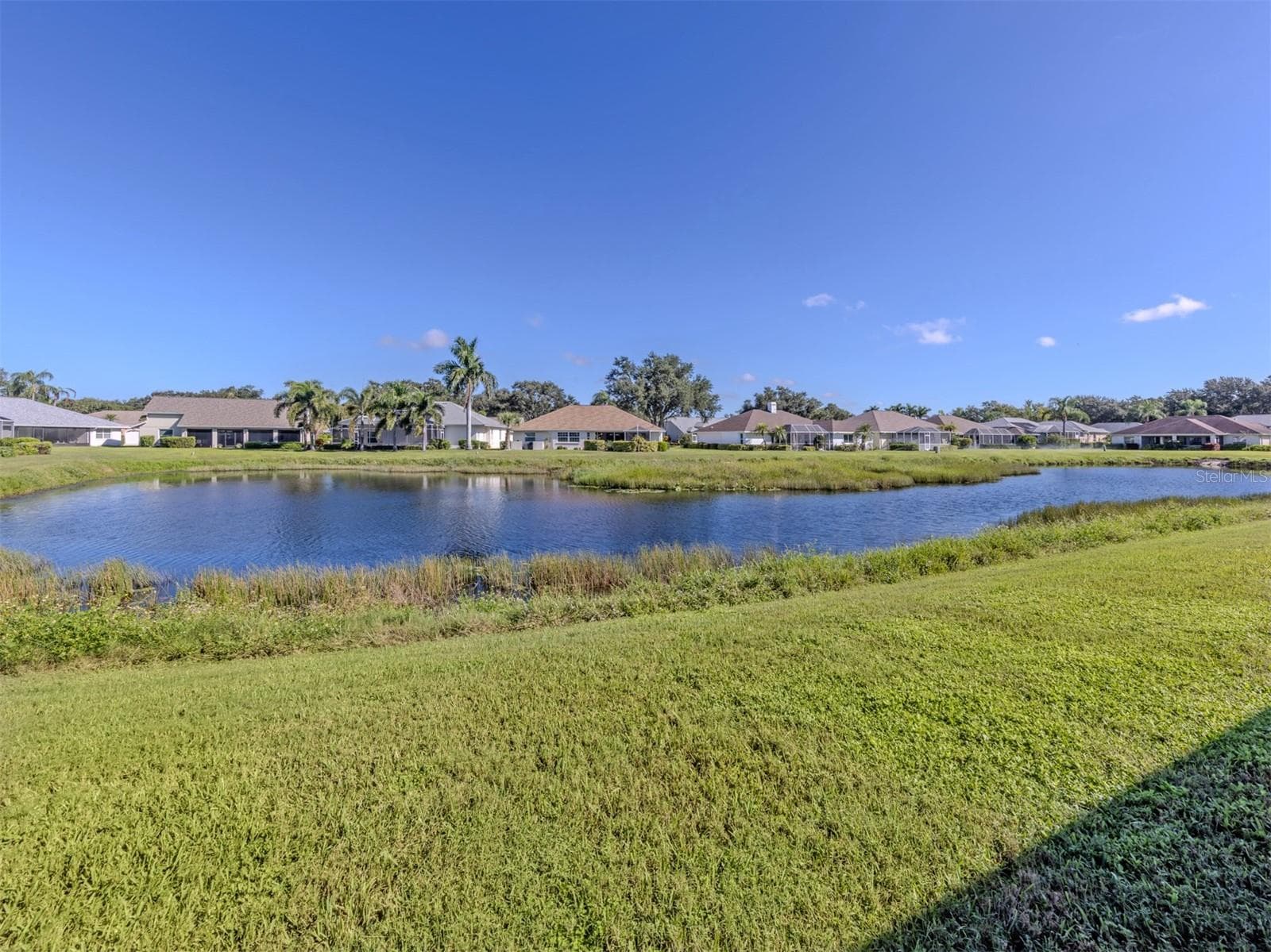 WOW! Now THIS is a backyard view worth falling in love with! A gorgeous stretch of shimmering lake, lush greenery, and picture-perfect Florida scenery creates a breathtaking backdrop that makes every day feel like a getaway. Just imagine calling this beautiful view your own! - 443 BERMUDA ISLES CIR, VENICE