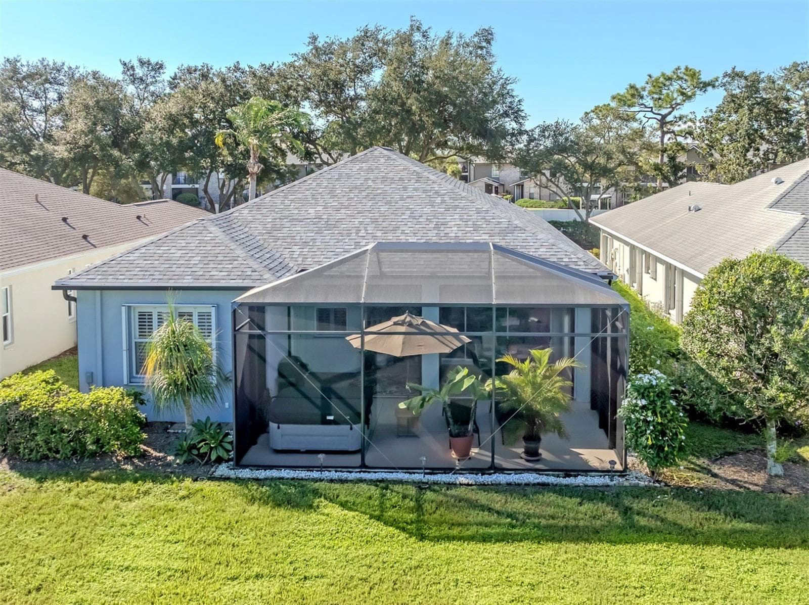 The backyard steals the show! This aerial angle reveals how beautifully the home opens toward the water, with its generous outdoor living area perfectly positioned to enjoy the scenery. Now that's a backyard worth bragging about! - 443 BERMUDA ISLES CIR, VENICE