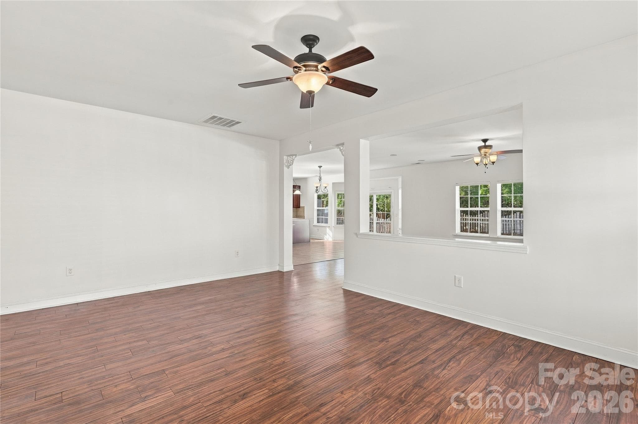 Wood-look floors flow through a spacious great room that's ready for your personal touch. - 327 Annaberg Lane, Monroe
