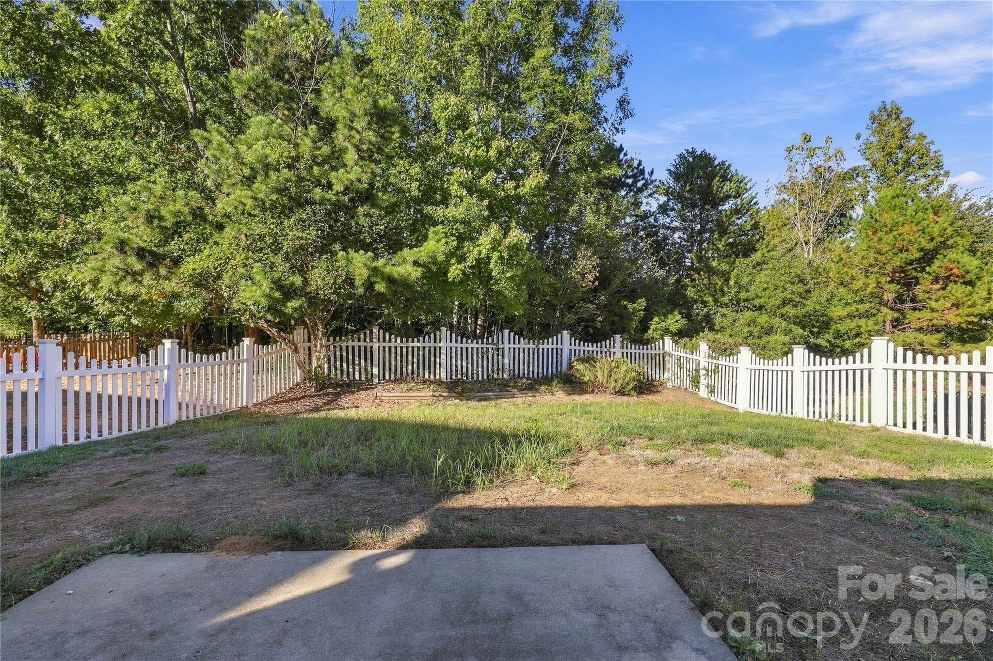 The fenced backyard has a patio that's perfect for grilling, gardening, or relaxing outdoors. - 327 Annaberg Lane, Monroe