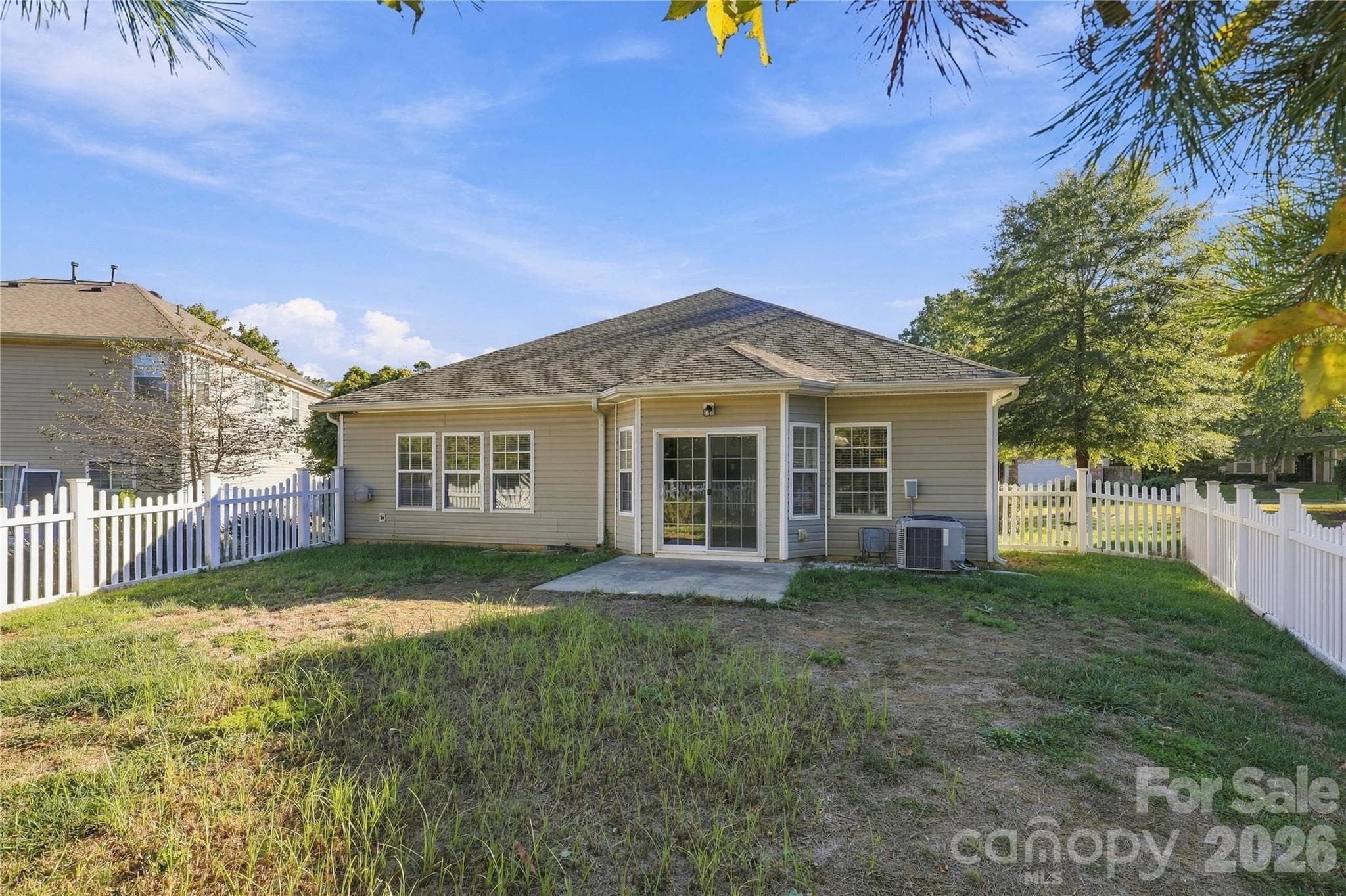 A rear view shows the generous backyard and the home's easy single-level layout. - 327 Annaberg Lane, Monroe