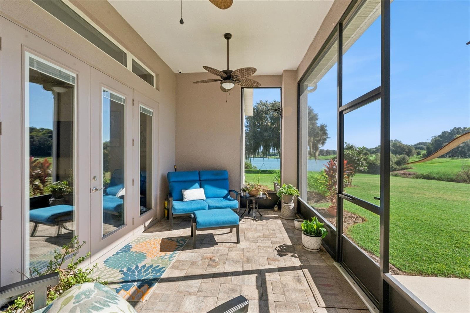 Covered lanai with pavers overlooking the water - 36819 WOLF CT, EUSTIS
