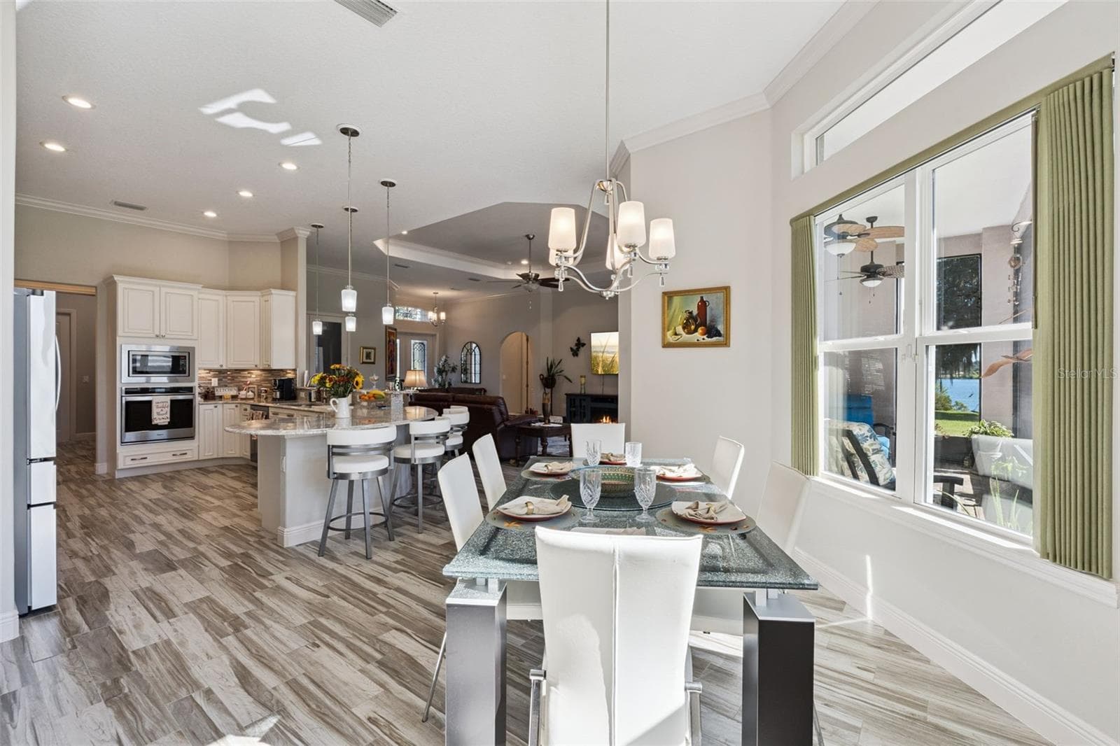 Casual dining area off the kitchen featuring scenic water views. - 36819 WOLF CT, EUSTIS