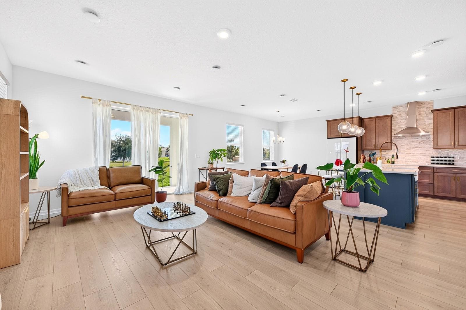 A bright, inviting interior features LUXURY VINYL PLANK FLOORING throughout. - 1785 PETIOLE PL, KISSIMMEE