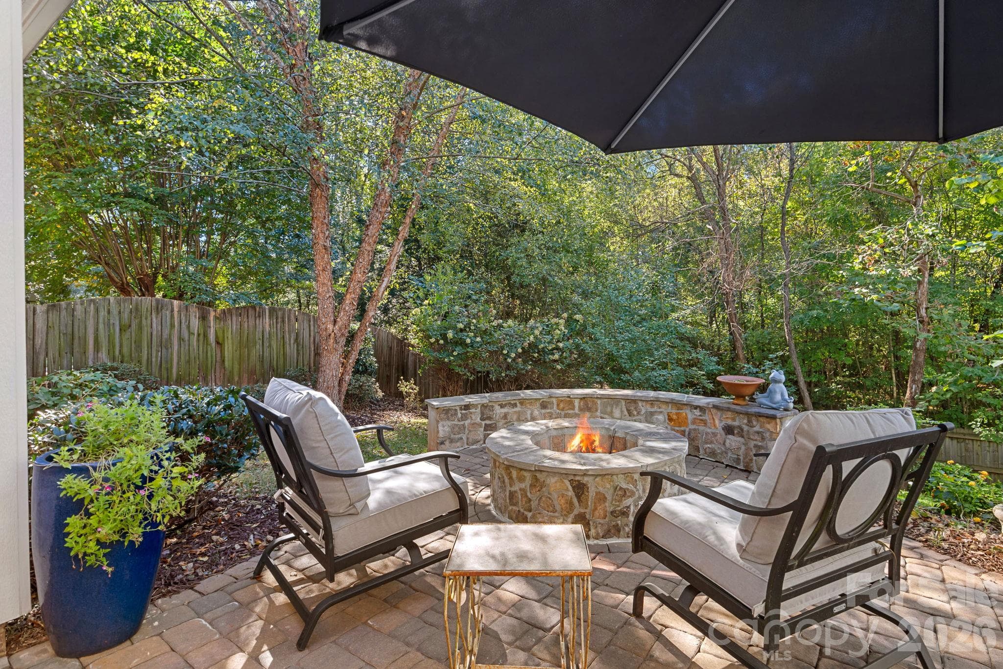 Patio with Firepit overlooking private backyard - 13326 Pierre Reverdy Drive, Davidson