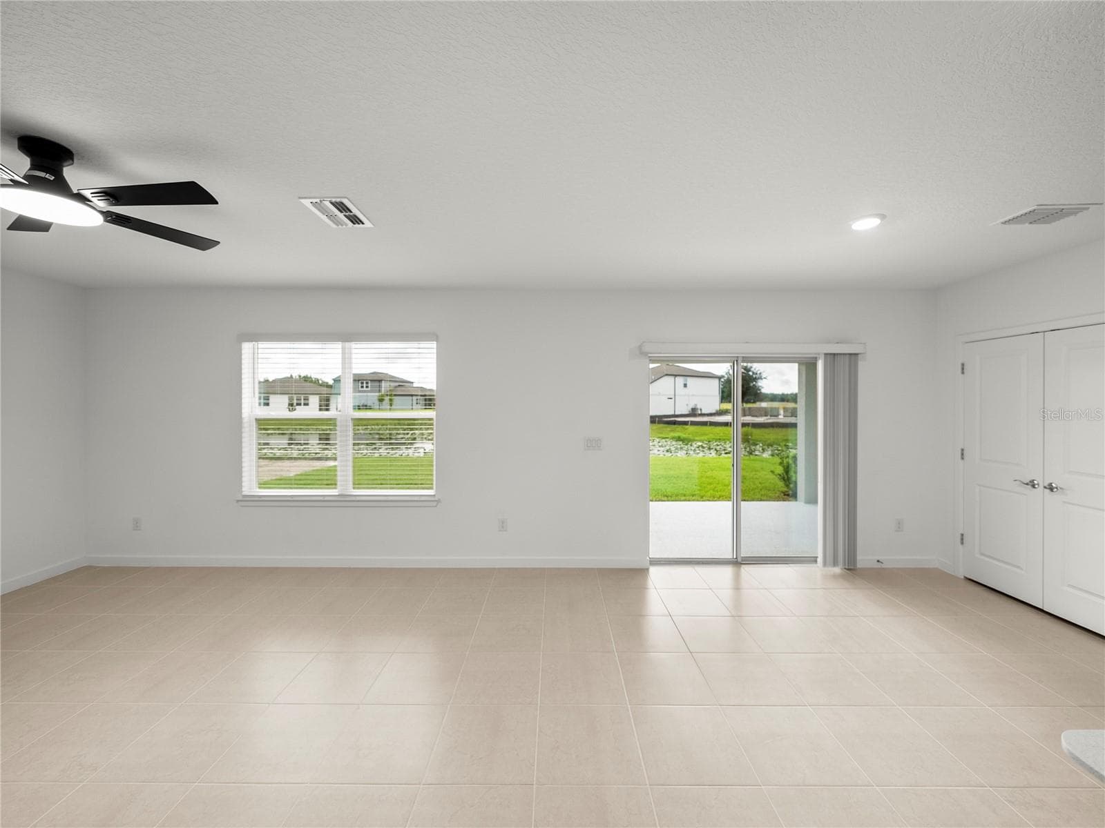 Large Open Living and Dining area with New LED Ceiling Fan & Convenient Floor Outlet - 1076 KISTNA DR, ZEPHYRHILLS