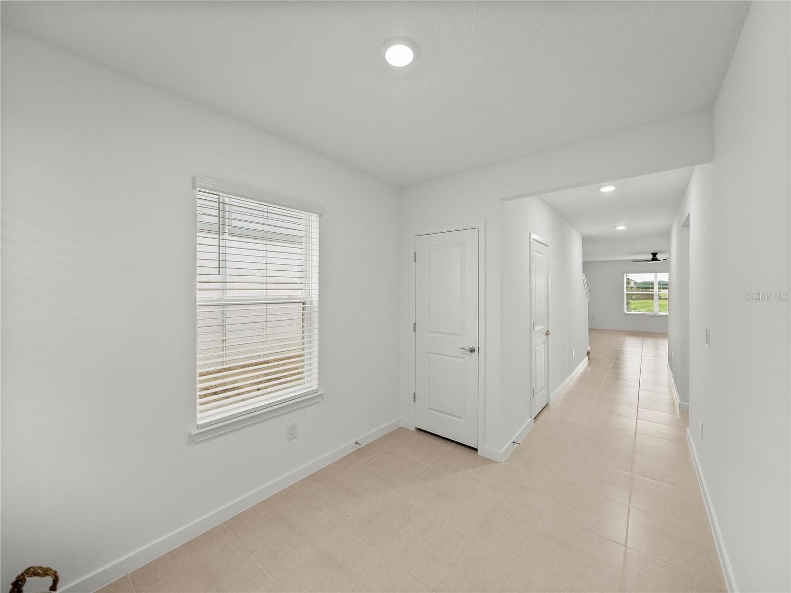 Foyer Mud Area with Coat Closet and Under Staircase Storage - 1076 KISTNA DR, ZEPHYRHILLS