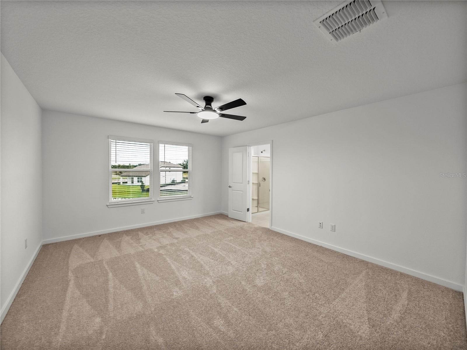 Primary Suite with New LED Ceiling Fan and Views to the Pond - 1076 KISTNA DR, ZEPHYRHILLS