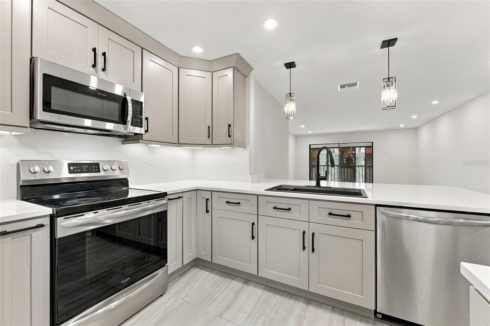 Open kitchen flows seamlessly into the rest of the floor plan - 2650 COUNTRYSIDE BLVD #A306, CLEARWATER