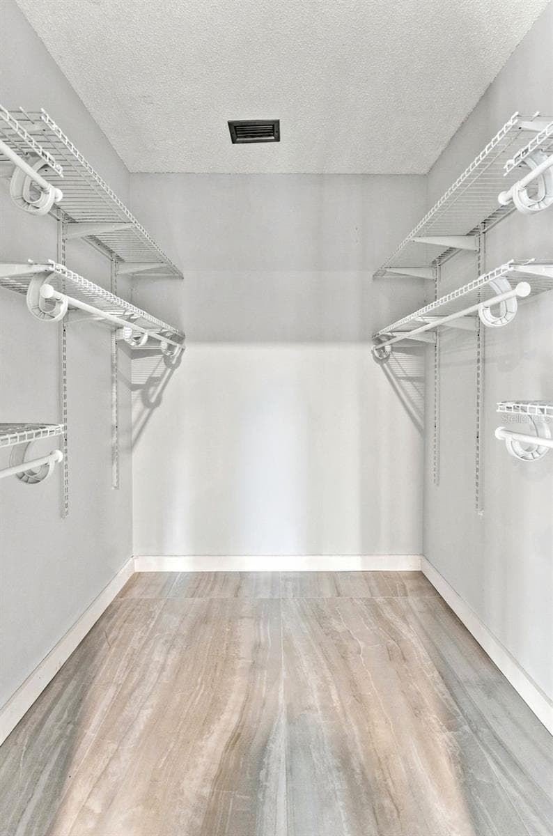 Walk-in primary closet offering plenty of storage space - 2650 COUNTRYSIDE BLVD #A306, CLEARWATER