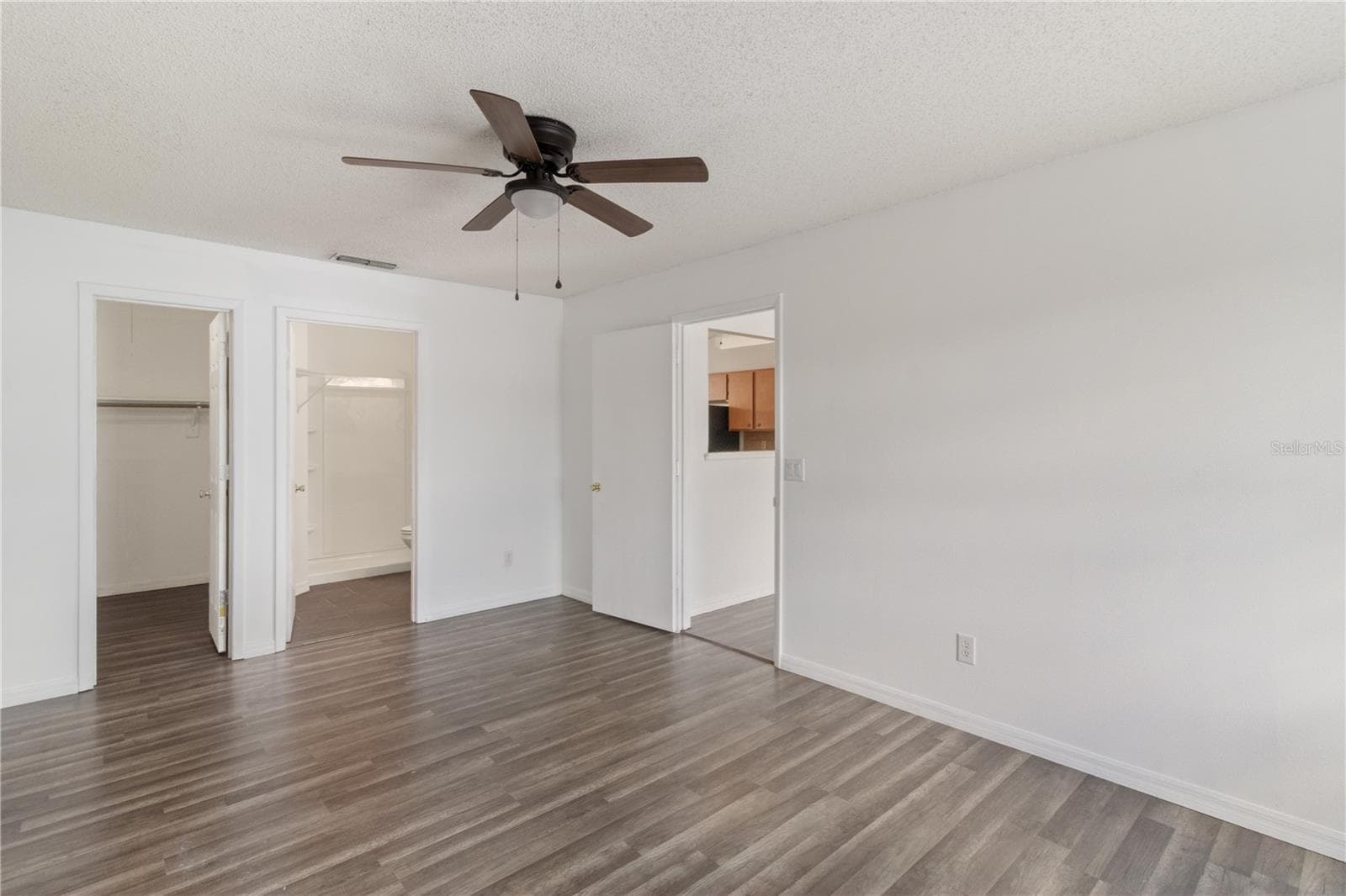 Primary Bedroom with View To Living Room, Bath, and Master Closet - 2957 GIMLET DR, DELTONA