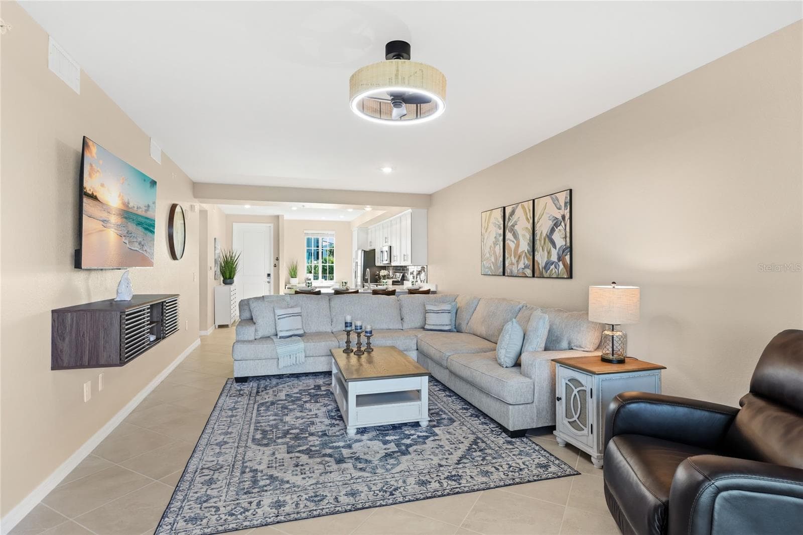 Living Room overlooking the spacious Lanai with beautiful golf course, water, and preserve views. - 17565 OPAL SAND DR #204, VENICE