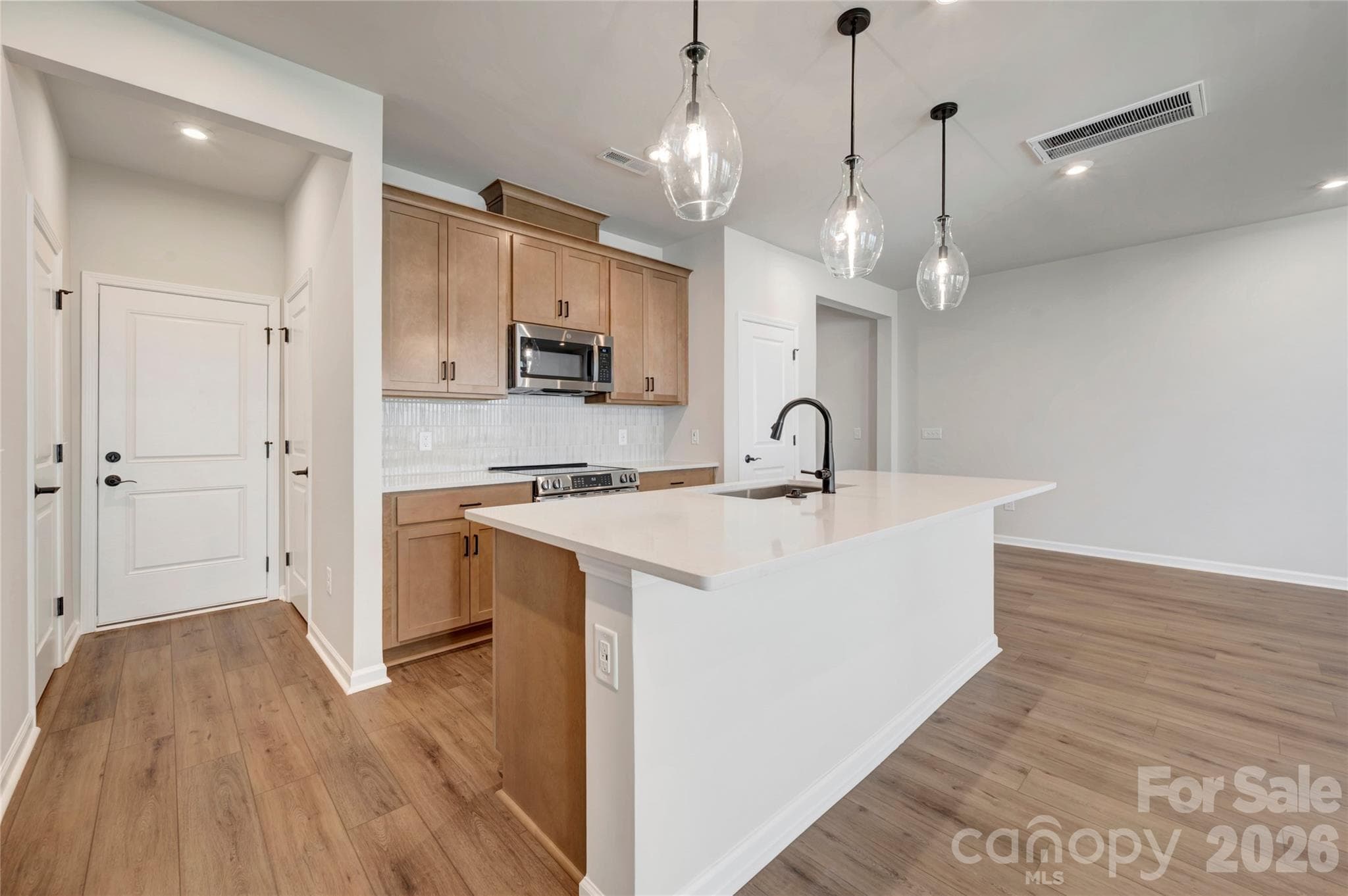 Light filled kitchen with warm brown cabinets - 707 Bowery Place, Cramerton