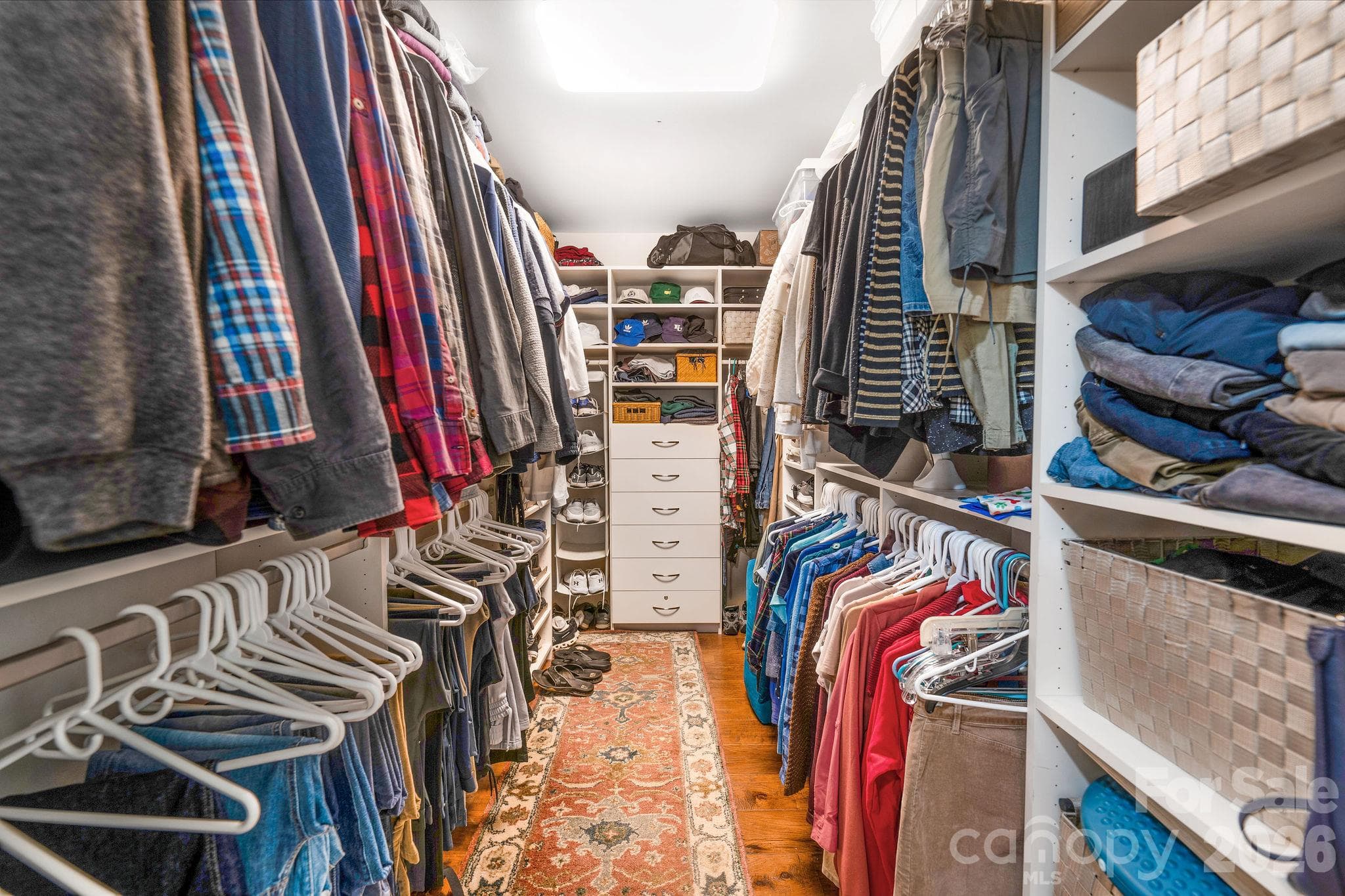 Spacious primary walk-in closet with custom built-in organization - 28 Penley Park Drive, Weaverville