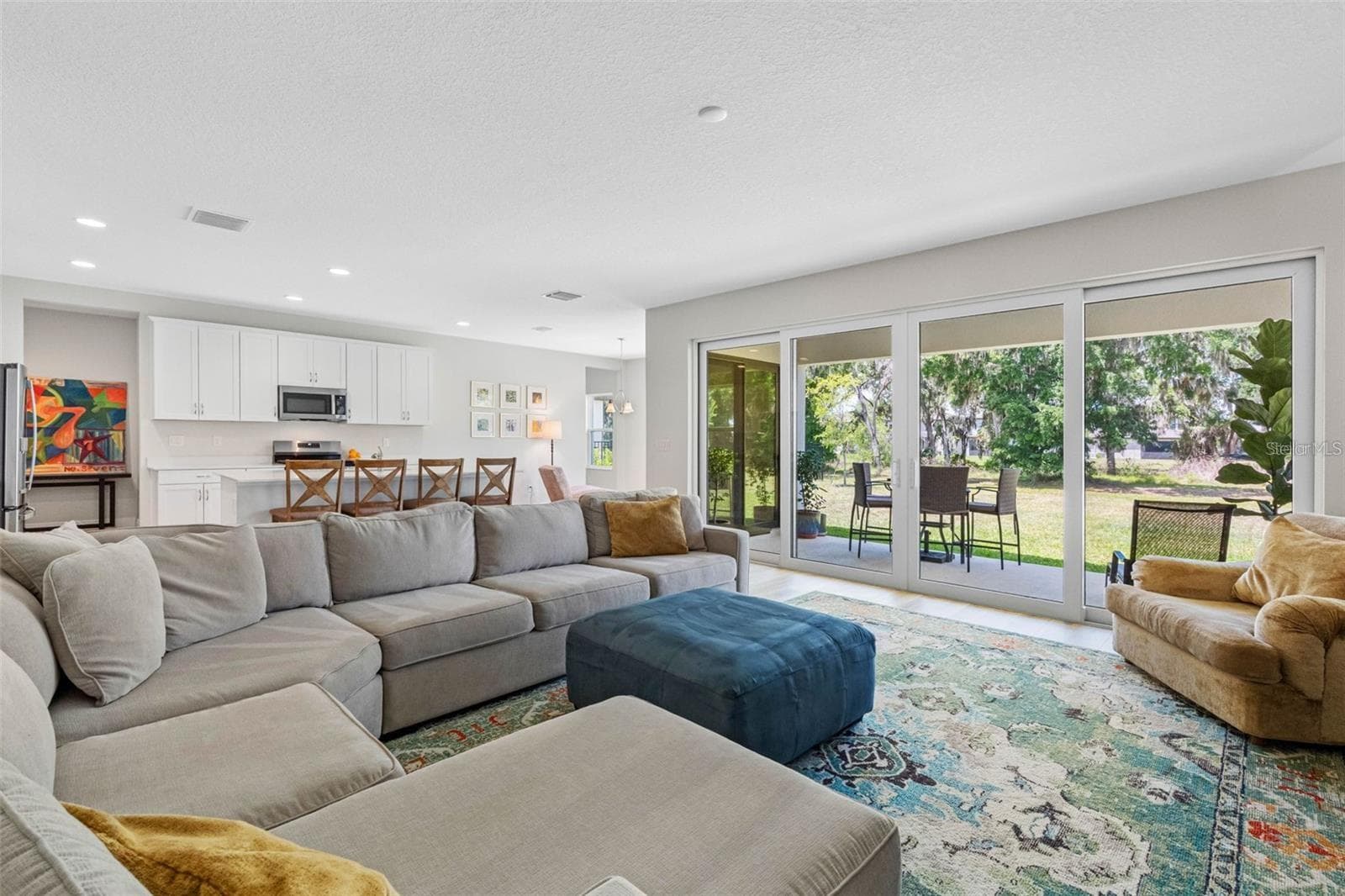 Open great room with a 16-foot sliding glass door to the covered lanai - 14868 SUMMER BRANCH DR, LITHIA