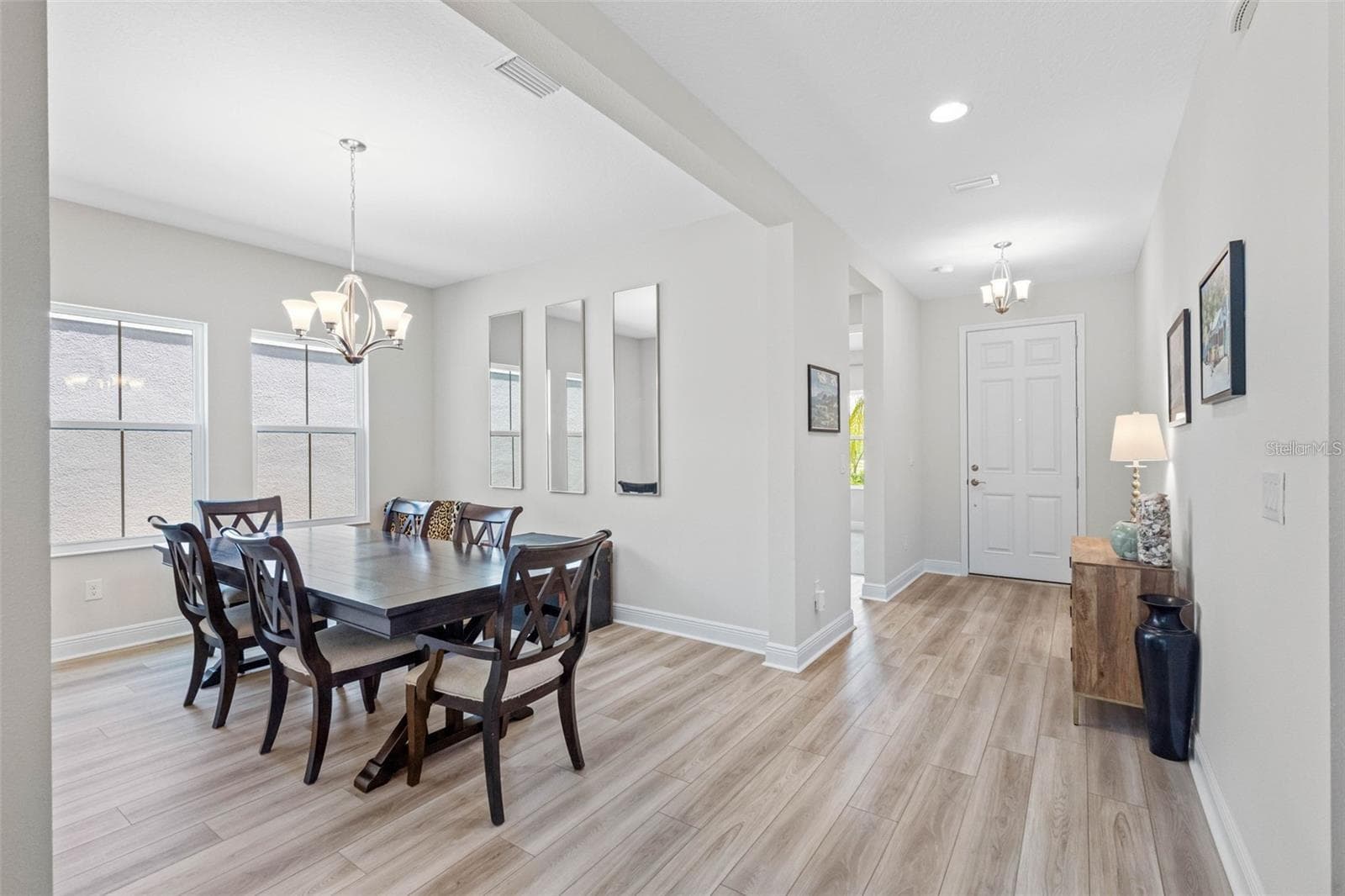 Formal dining room and welcoming foyer with luxury vinyl plank floors - 14868 SUMMER BRANCH DR, LITHIA