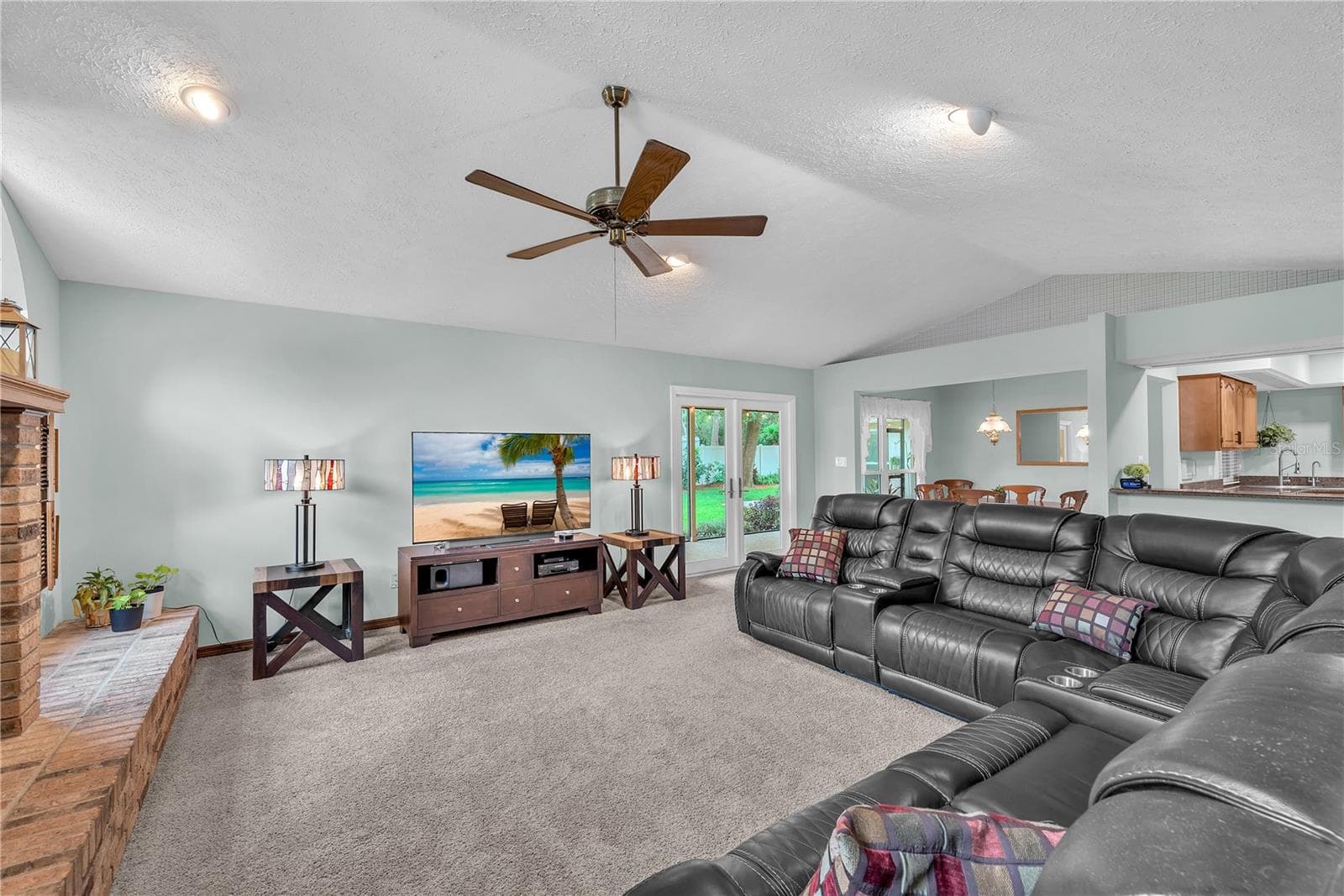 Recently upgraded impact-resistant French doors open to a spacious, covered and screened porch, perfect for enjoying the outdoors in comfort. - 2421 OAK LANDING DR, BRANDON