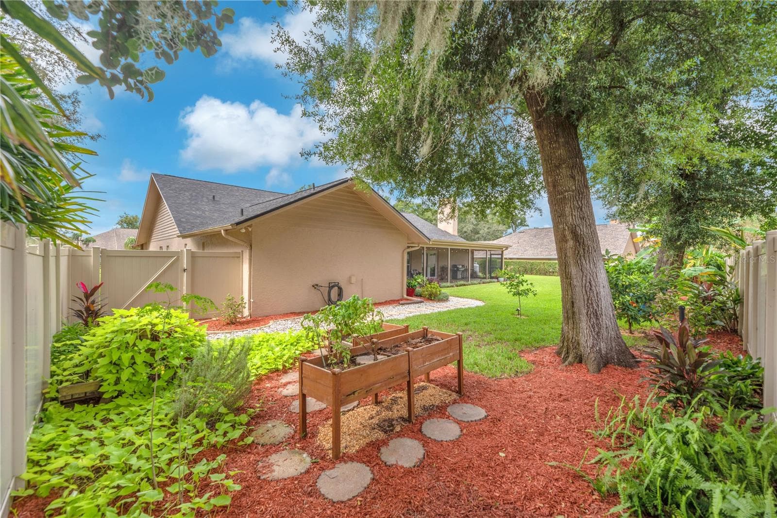 The backyard is partially enclosed with low-maintenance PVC fencing for added privacy and easy upkeep. - 2421 OAK LANDING DR, BRANDON