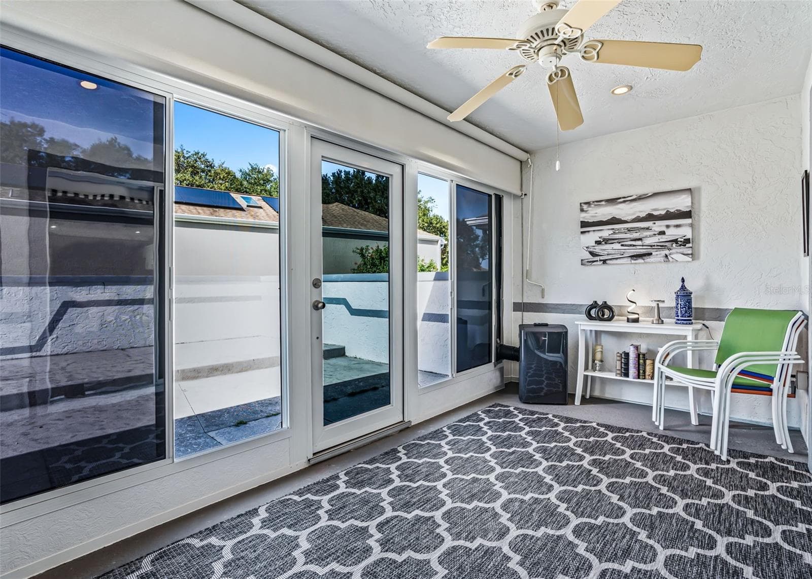 Enclosed Fl rm. w/ portable A/C unit. new black ceiling fan will be installed this week. - 17864 SE 115TH CT, SUMMERFIELD