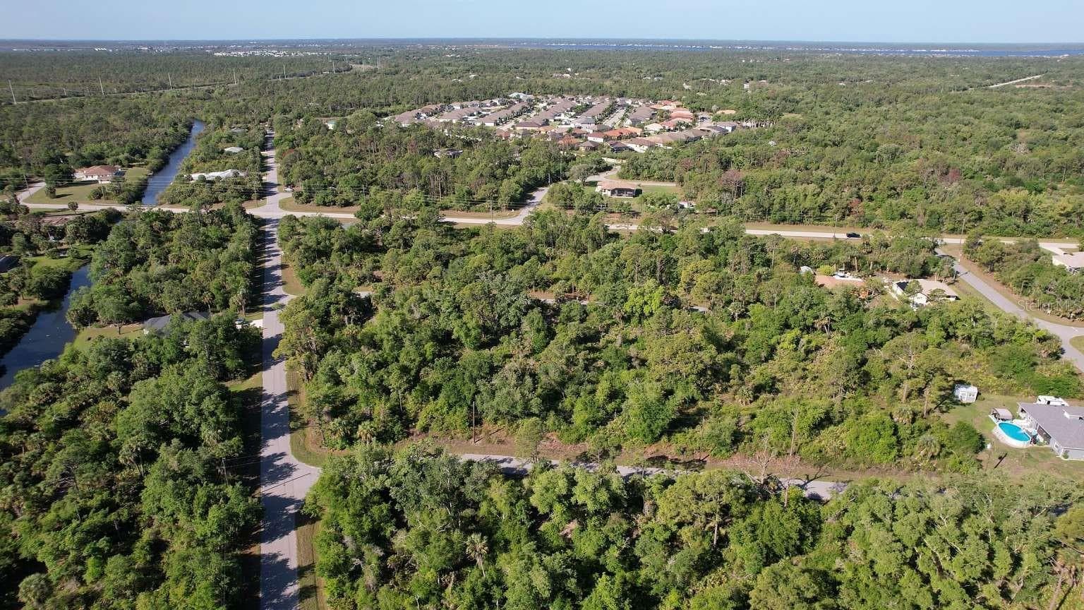 Aerial view of the surrounding area; nearby water features are not part of this property and do not establish access rights. - 1532 CHAFFIN LN, PORT CHARLOTTE