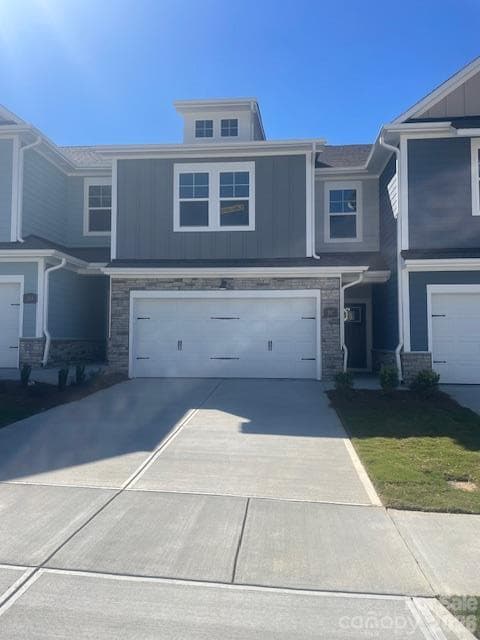 Exterior with stone accent around the 2 car garage. The driveway provides ample parking for you and your guests - 257 Alluvium Lane, Waxhaw