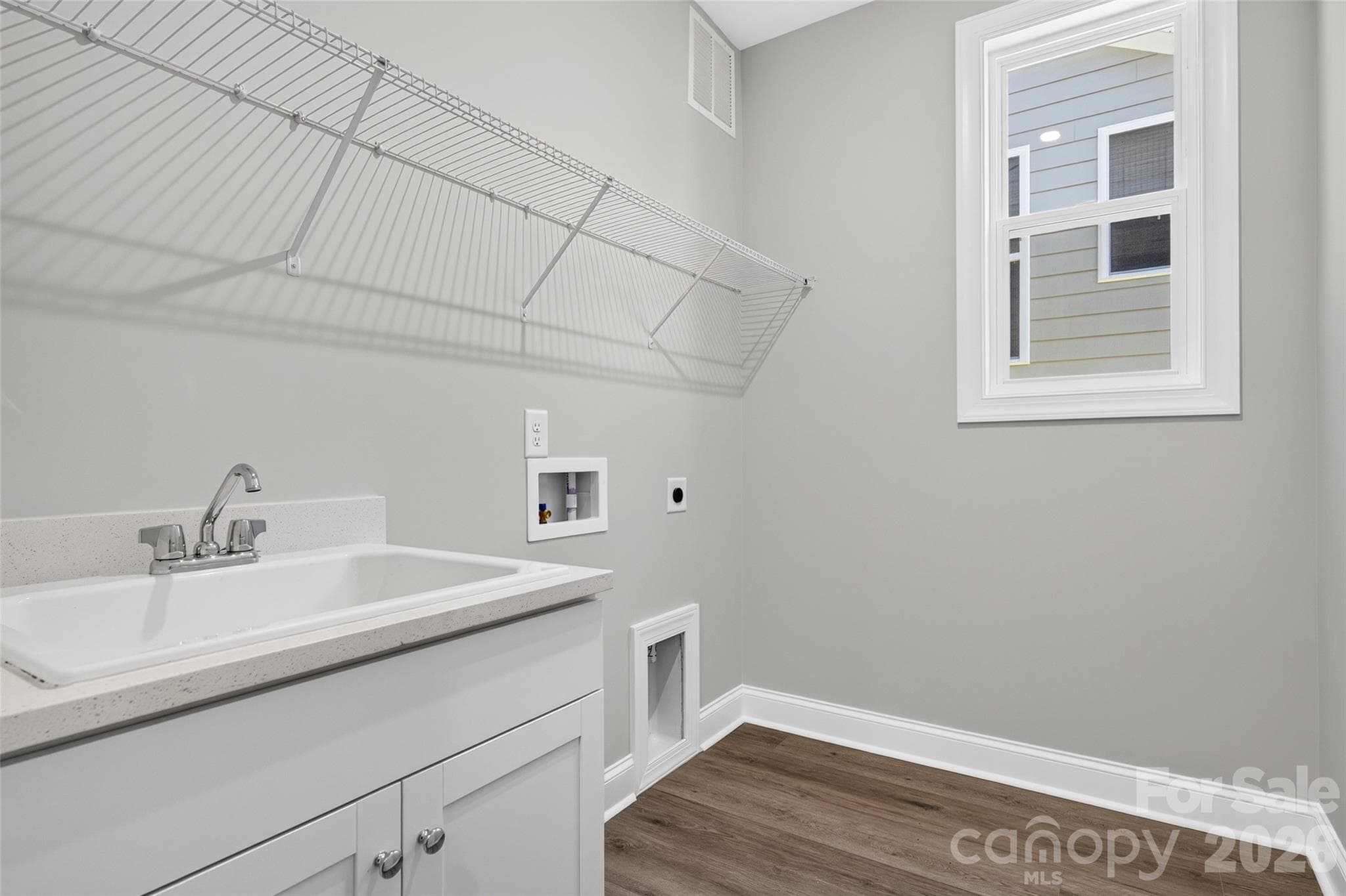 Generous-sized Laundry Room with built-in Laundry Sink - 13413 Cozy Court, Charlotte