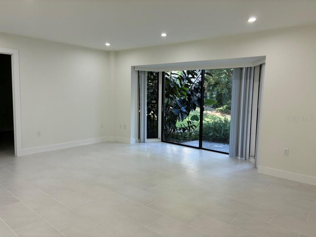 Living room and rear porch - 5999 VILLAGE CIR #990, ORLANDO
