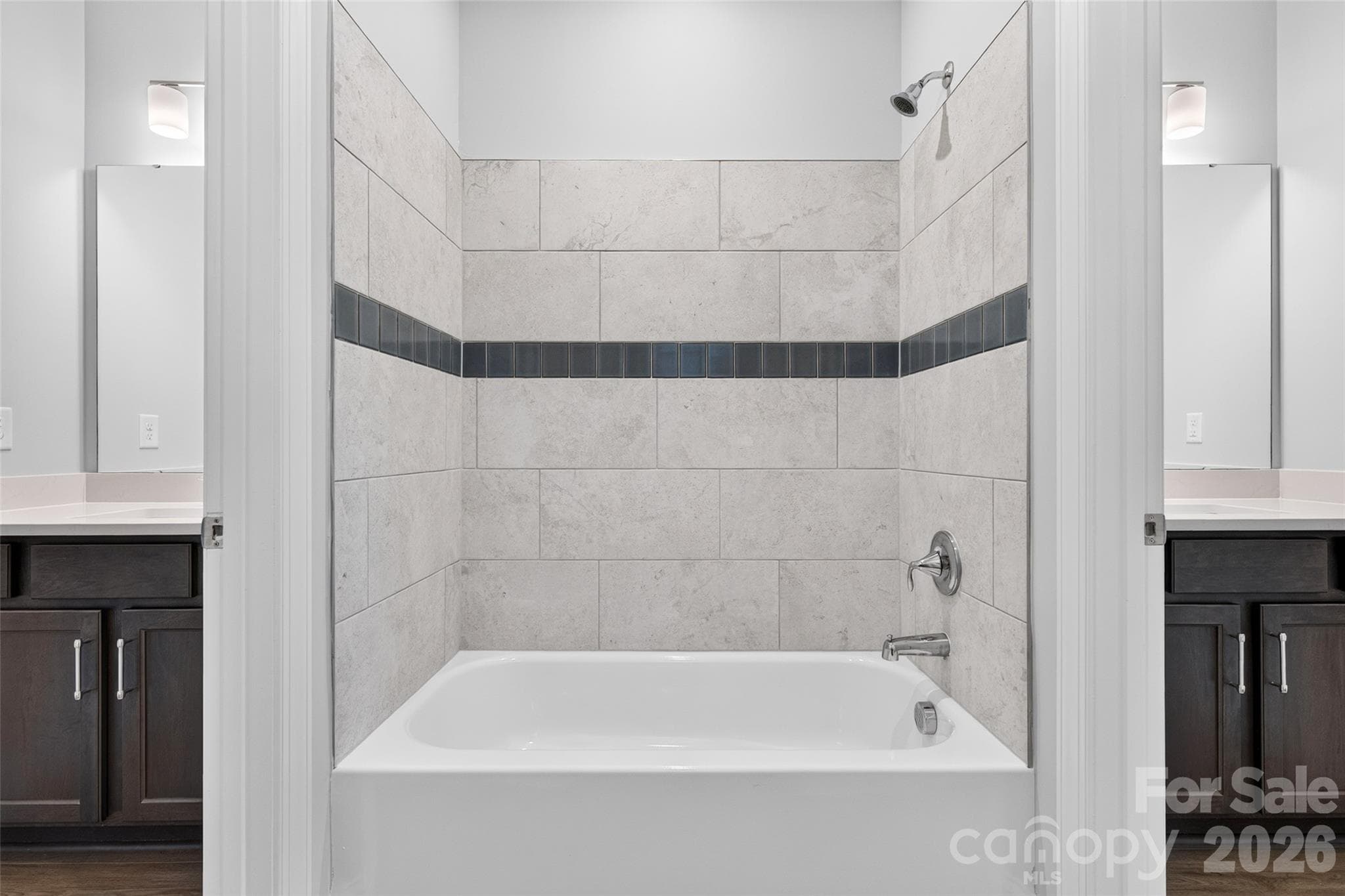 Guest bathroom with bath tub and full tile surround in shared "Jack and Jill" bathroom - 13413 Cozy Court, Charlotte
