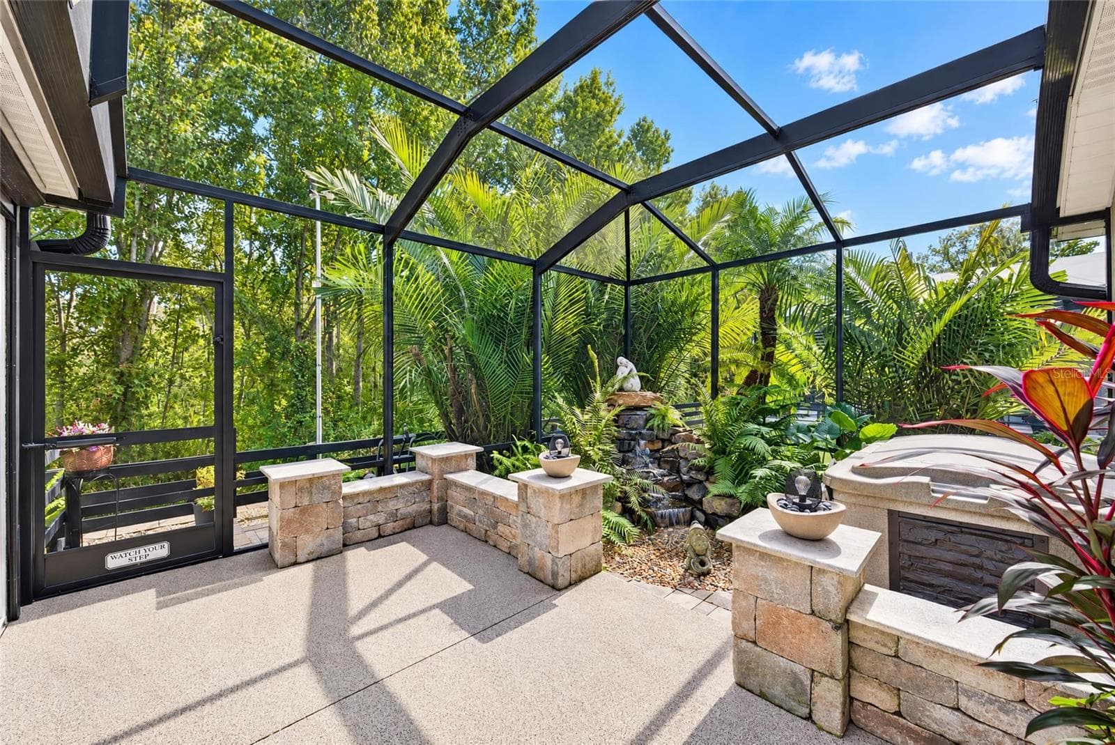 Patio and waterfall under birdcage. - 3665 VALLEYBROOK WAY, THE VILLAGES