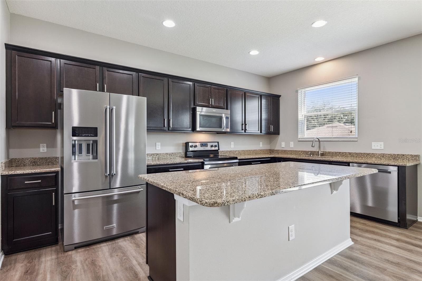 Gourmet kitchen featuring granite counter counter tops - 13612 LARANJA ST, CLERMONT