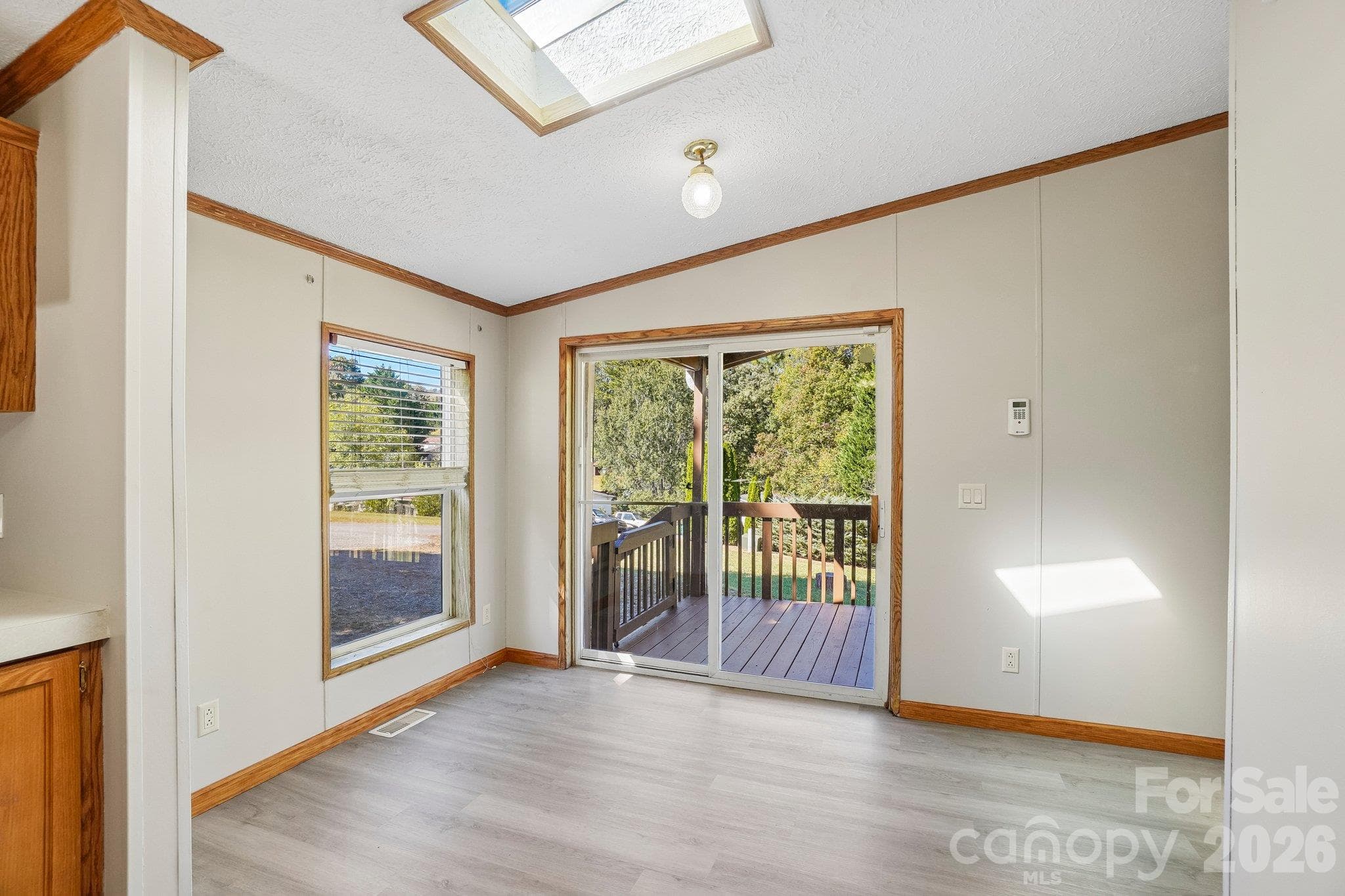 A dining area leads to a sliding door onto the covered deck. - 202 Banyan Road, Candler