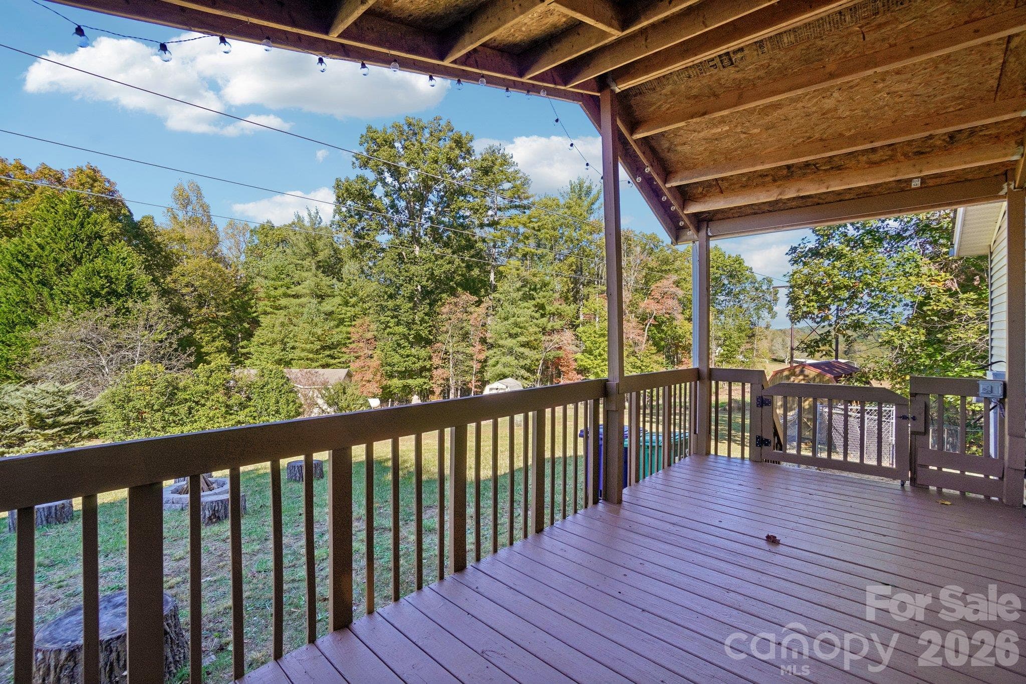The deck looks out over a spacious side yard - 202 Banyan Road, Candler
