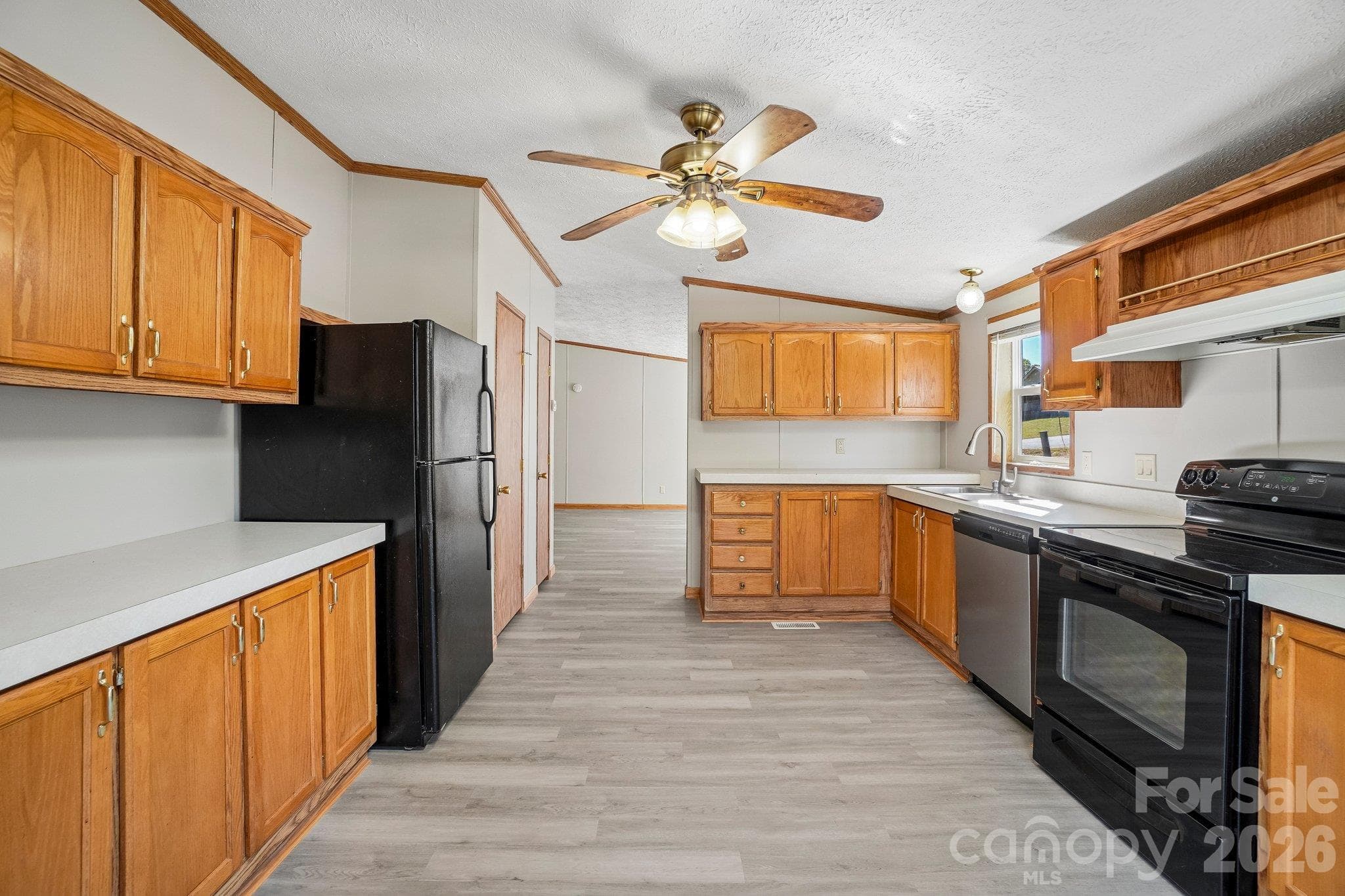 Back out into the kitchen, note the open feel as you look back through the kitchen. - 202 Banyan Road, Candler