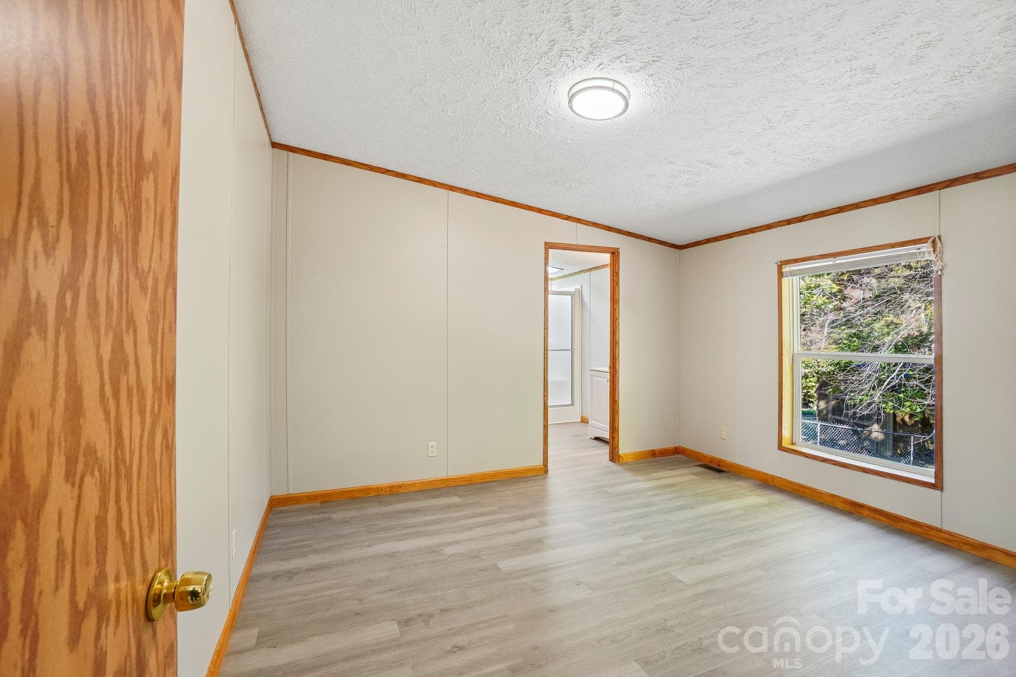 In the family room, to the left of the fireplace, enter the primary bedroom. - 202 Banyan Road, Candler
