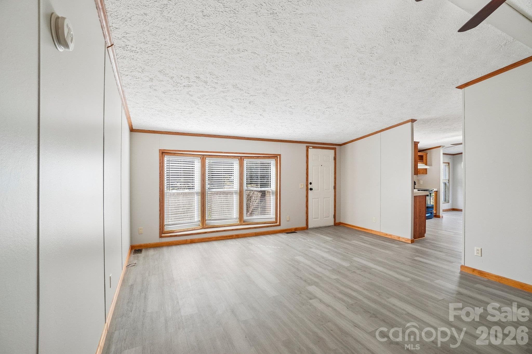 Exiting the bathroom, a bay window is in view at the front of the house. - 202 Banyan Road, Candler