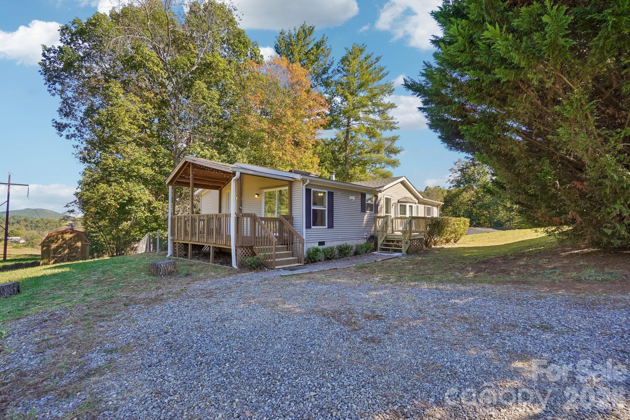 A gravel driveway accommodates two vehicles, and could be expanded. - 202 Banyan Road, Candler