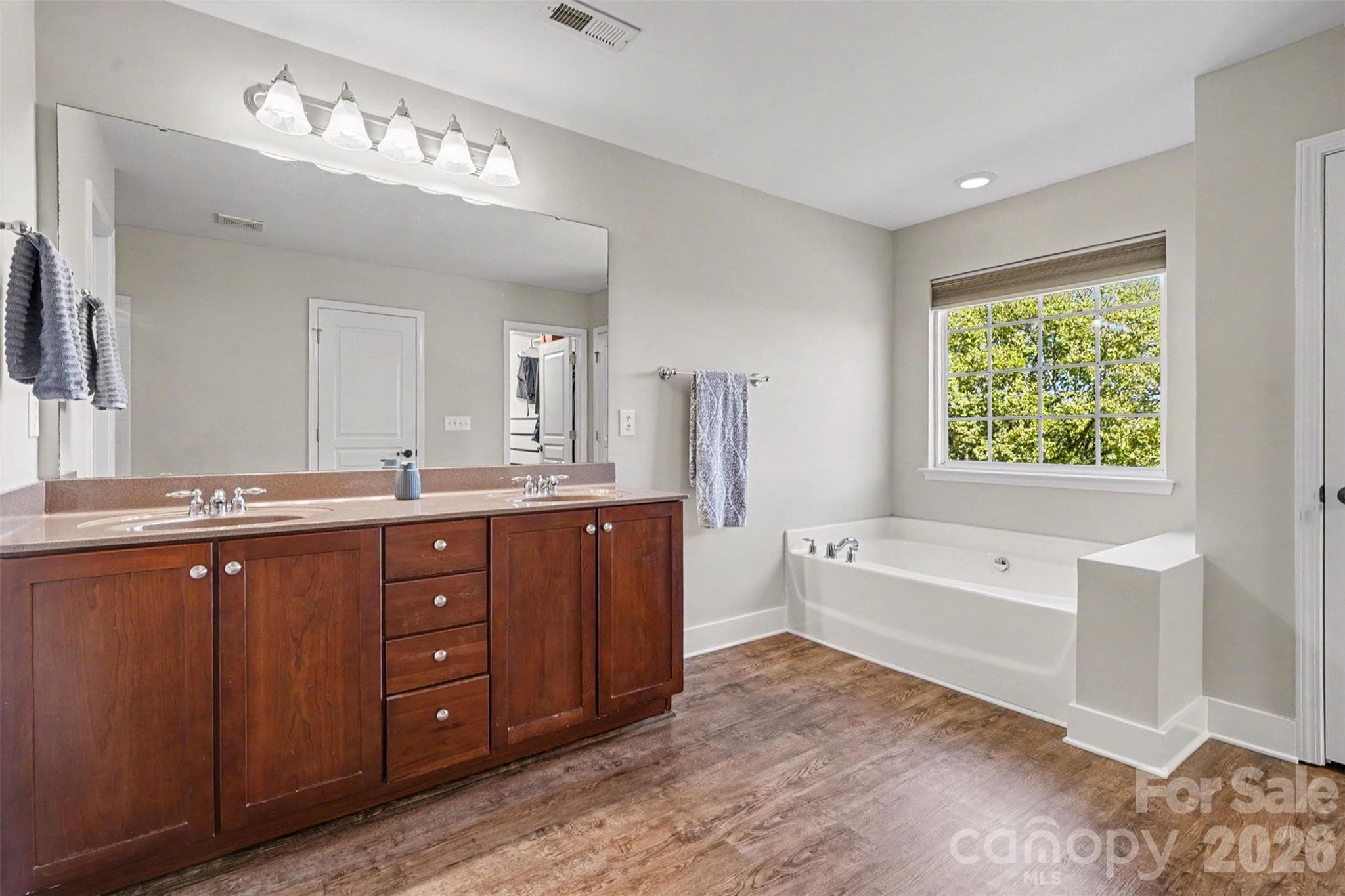 Primary Bathroom features Fresh-Neutral Paint, Dual Sinks, lots of storage on the oversized vanity, garden tub! - 3585 Leighton Drive SW, Concord