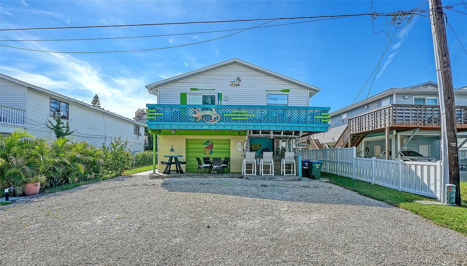 Front of 2514 Avenue B with gravel driveway with four assigned parking spaces. - 2514 AVENUE B, BRADENTON BEACH
