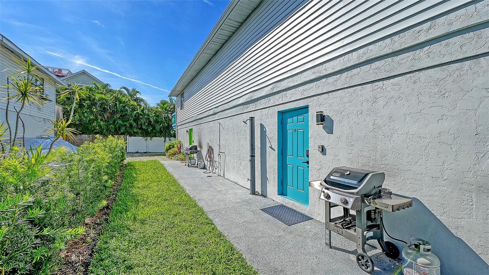 Both units have left side entrances. Blue door, Unit A. Green door, Unit B. Both units have a propane grill. - 2514 AVENUE B, BRADENTON BEACH