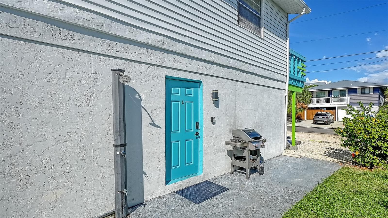 Both units have left side entrances. Blue door, Unit A. Both units have a propane grill. Common exterior shower that both units share. - 2514 AVENUE B, BRADENTON BEACH
