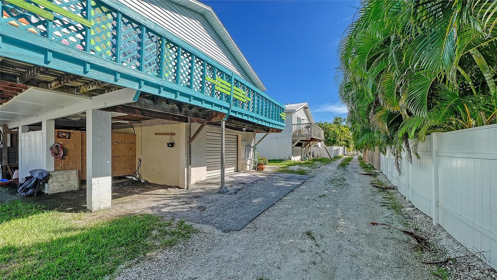 Rear of 2514 Avenue B. Common laundry in wooden laundry room, ground floor. - 2514 AVENUE B, BRADENTON BEACH
