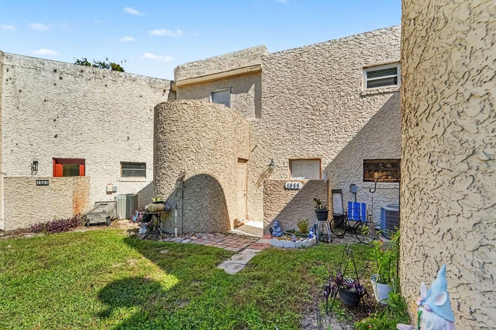 Distinctive Circular Arch Exterior with Multi-Level Terracotta Patio - 1055 ENCOURTE GREEN, APOPKA