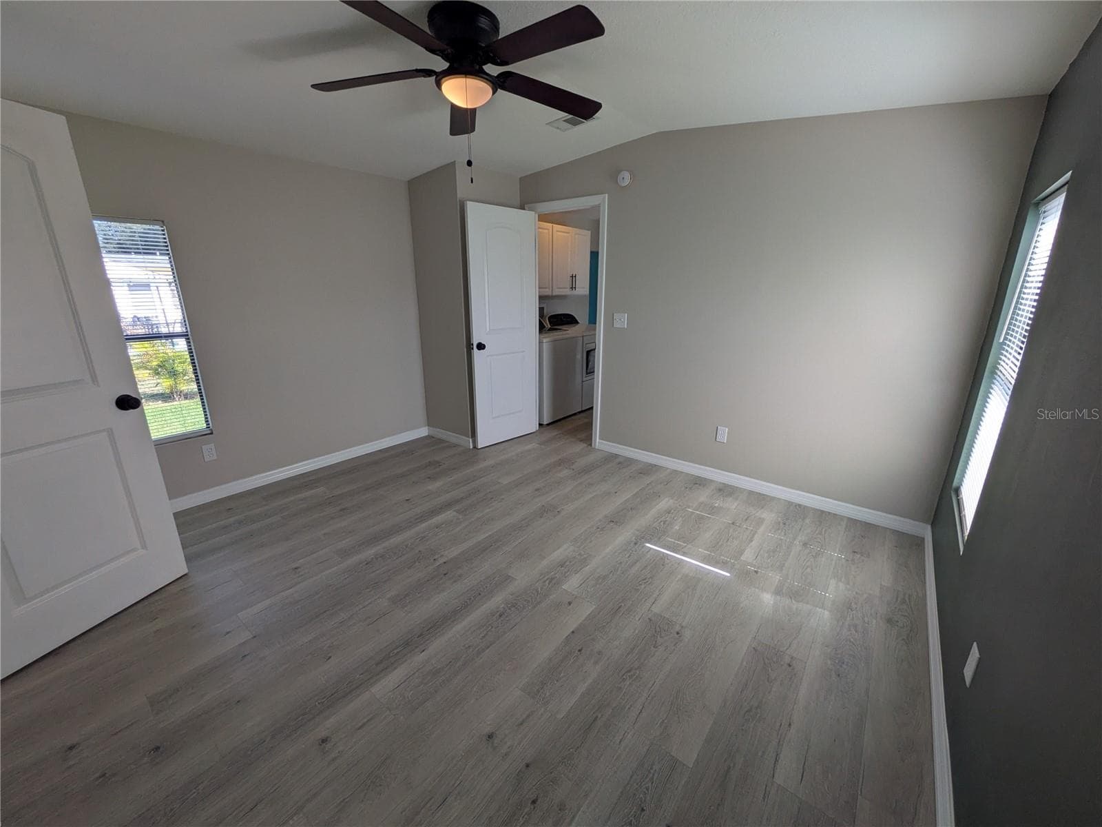 PRIMARY BEDROOM FROM BATHROOM - 3125 BAYBERRY AVE, PUNTA GORDA