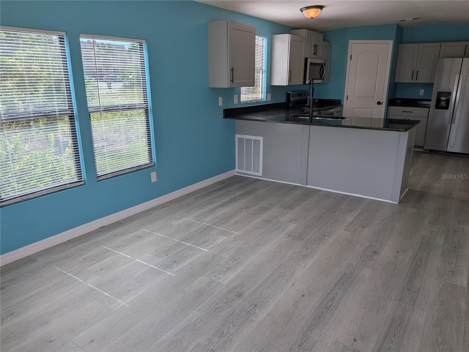 LIVING AREA FACING KITCHEN - 3125 BAYBERRY AVE, PUNTA GORDA