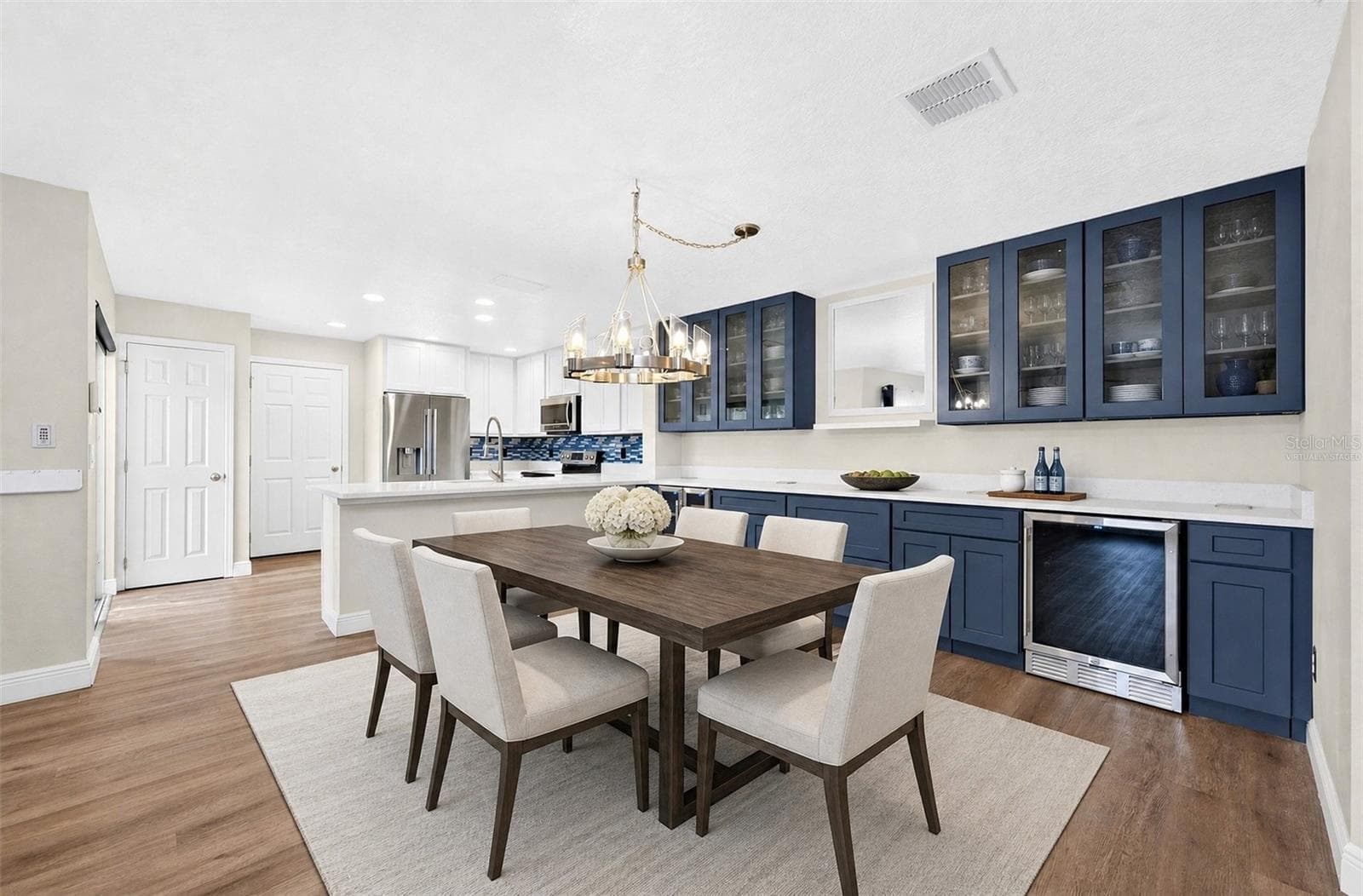 Nearby, the Dining Room is elevated by the STUNNING CUSTOM COFFEE, WINE AND BEVERAGE BAR (2025)—a beautiful and functional addition that makes hosting friends and family even more special. Virtually Staged - 13028 AUBURN COVE LN, ORLANDO