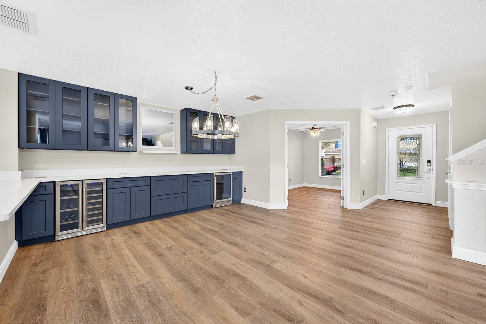 The open plan features an entry with custom glass entry door, full bath, and french doors on the first level open to a versatile FLEX SPACE! - 13028 AUBURN COVE LN, ORLANDO